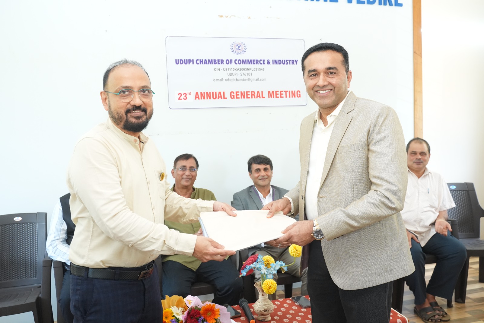 Handing over papers at the AGM