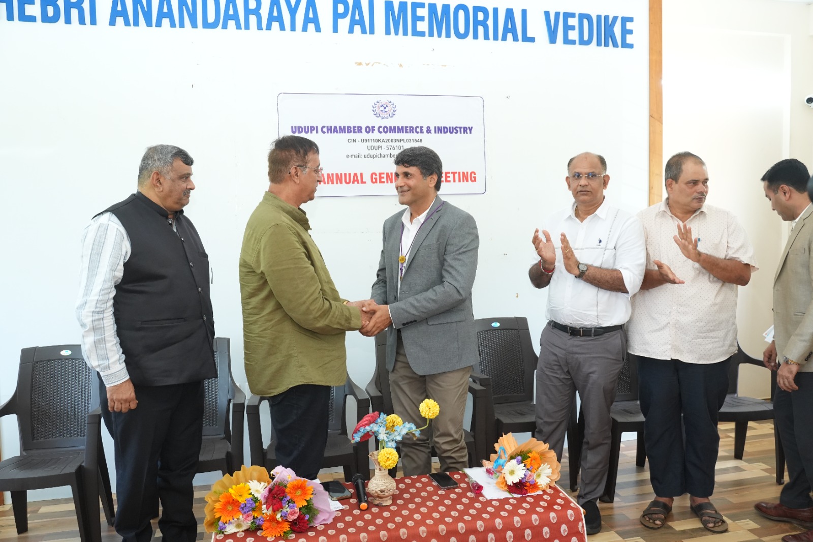 Office bearers greet each other at the AGM